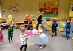 Dzieci bawią się balonami przy muzyce.